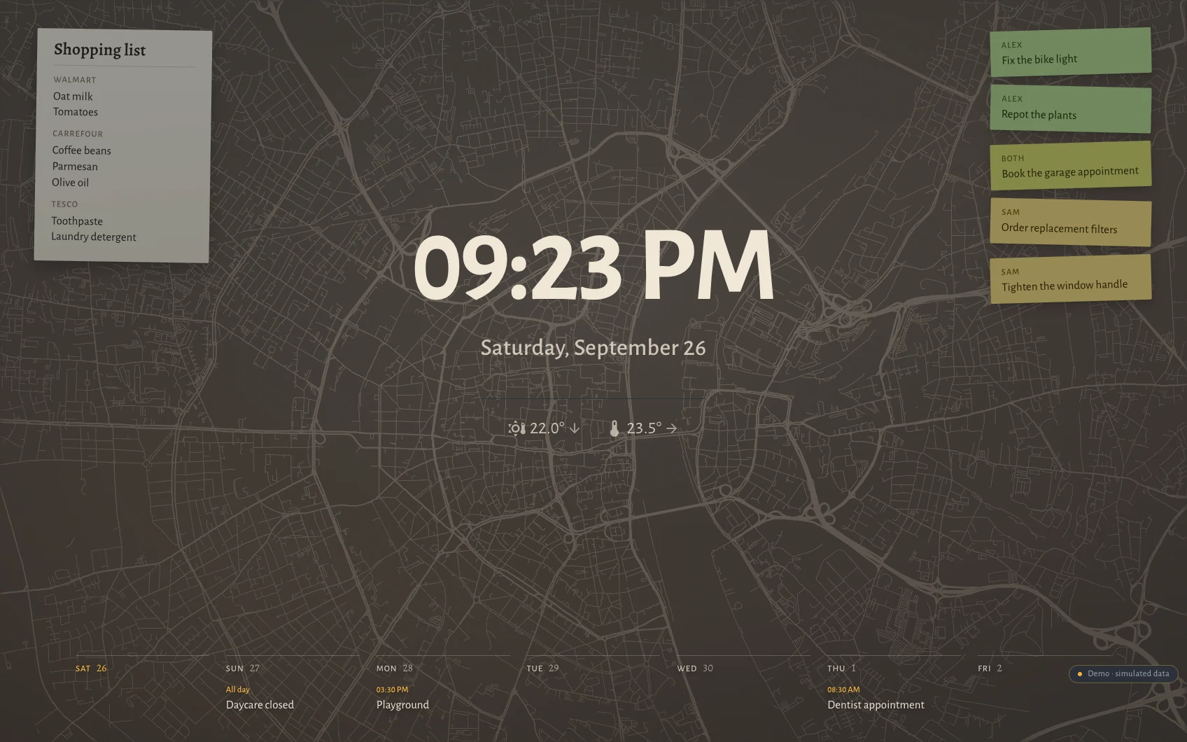 The Hauser standby screen at night in Cologne: clock, date, the week as seven columns along the bottom, post-its and the shopping list over a faint street map showing the Ring around the old town and the bend of the Rhine.