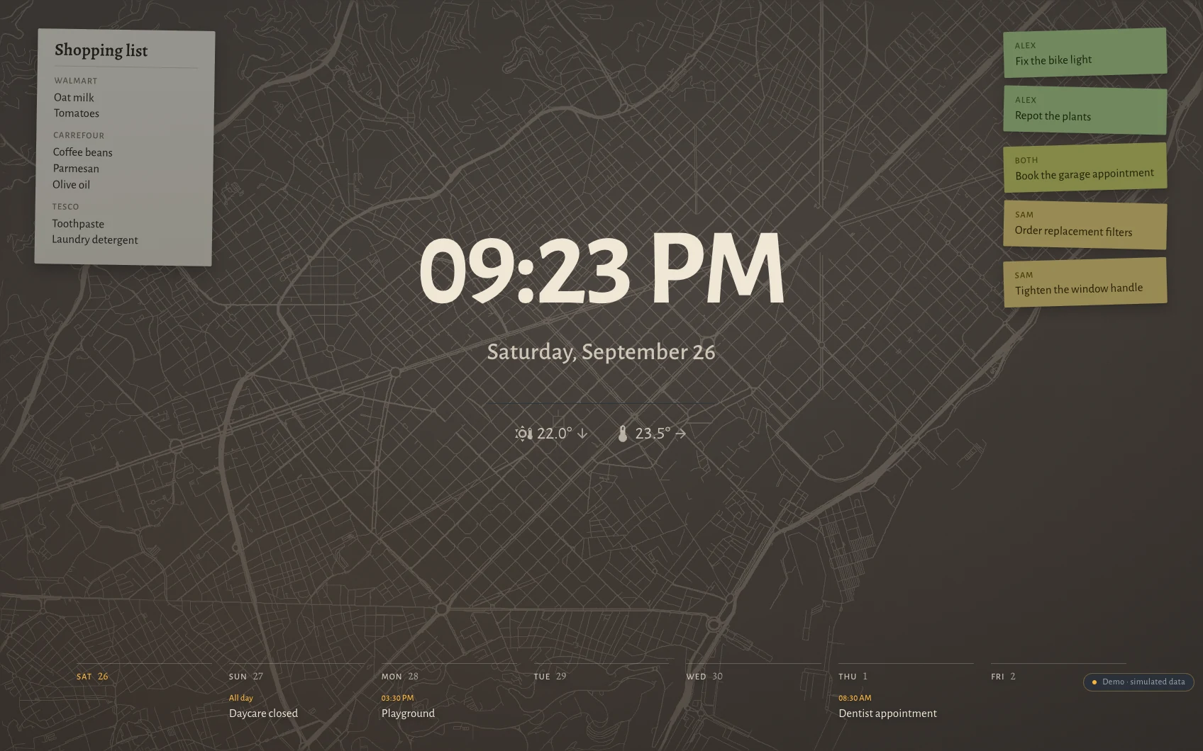 The Hauser standby screen at night in Barcelona: clock, date, the week as seven columns along the bottom, post-its and the shopping list over a faint street map showing the Eixample grid cut by the Diagonal.