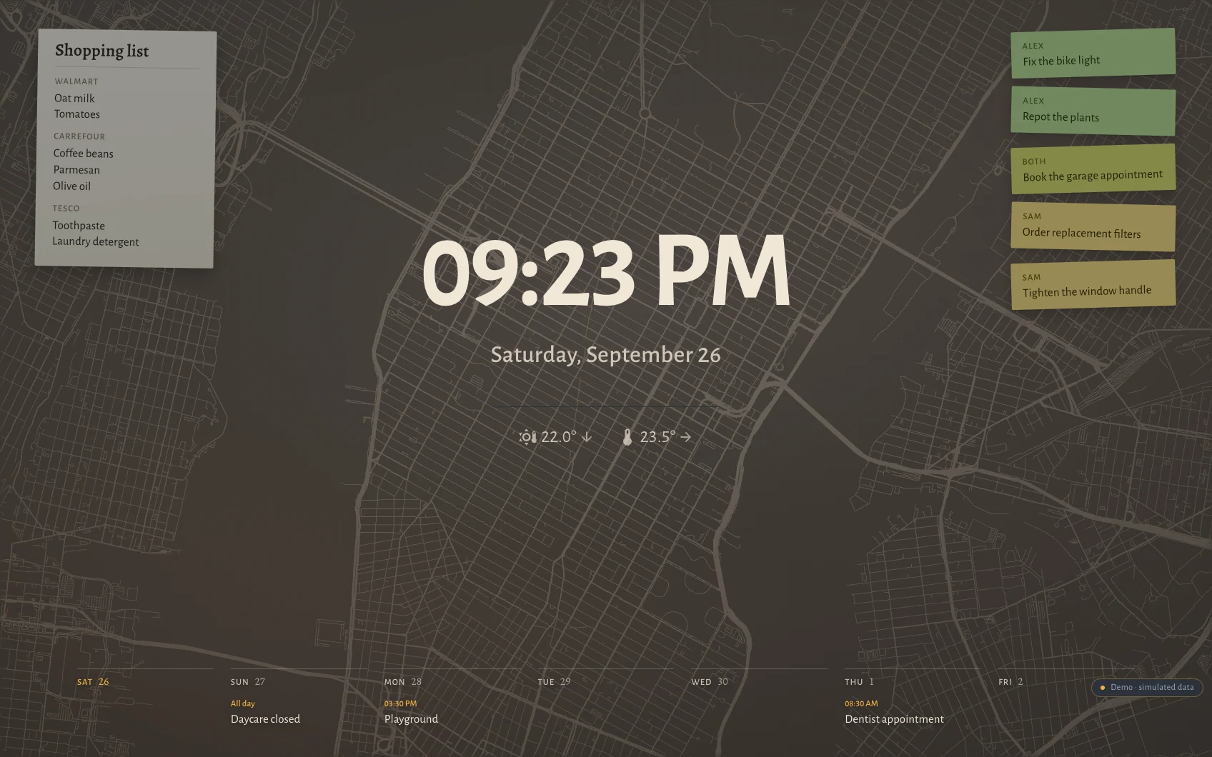 The Hauser standby screen at night in New York: clock, date, the week as seven columns along the bottom, post-its and the shopping list over a faint street map showing the Manhattan grid with Broadway across it.
