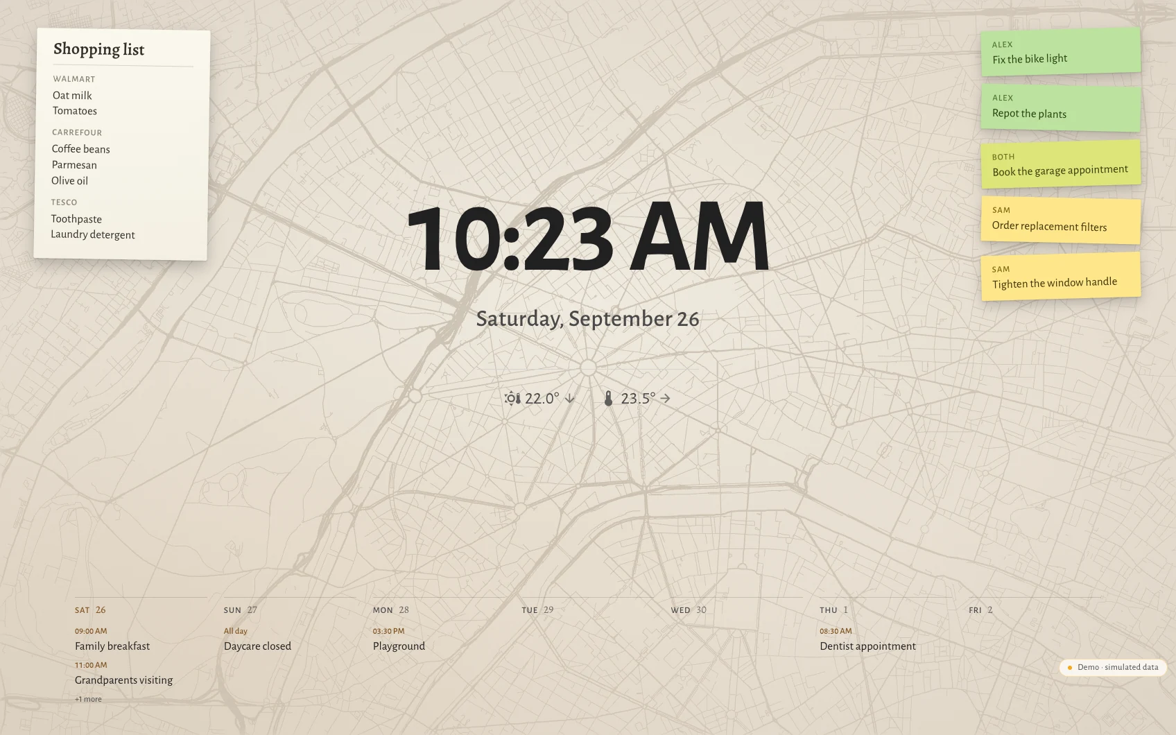 The Hauser standby screen by day in Paris: clock, date, the week as seven columns along the bottom, post-its and the shopping list over a faint street map showing the avenues meeting at the Étoile.