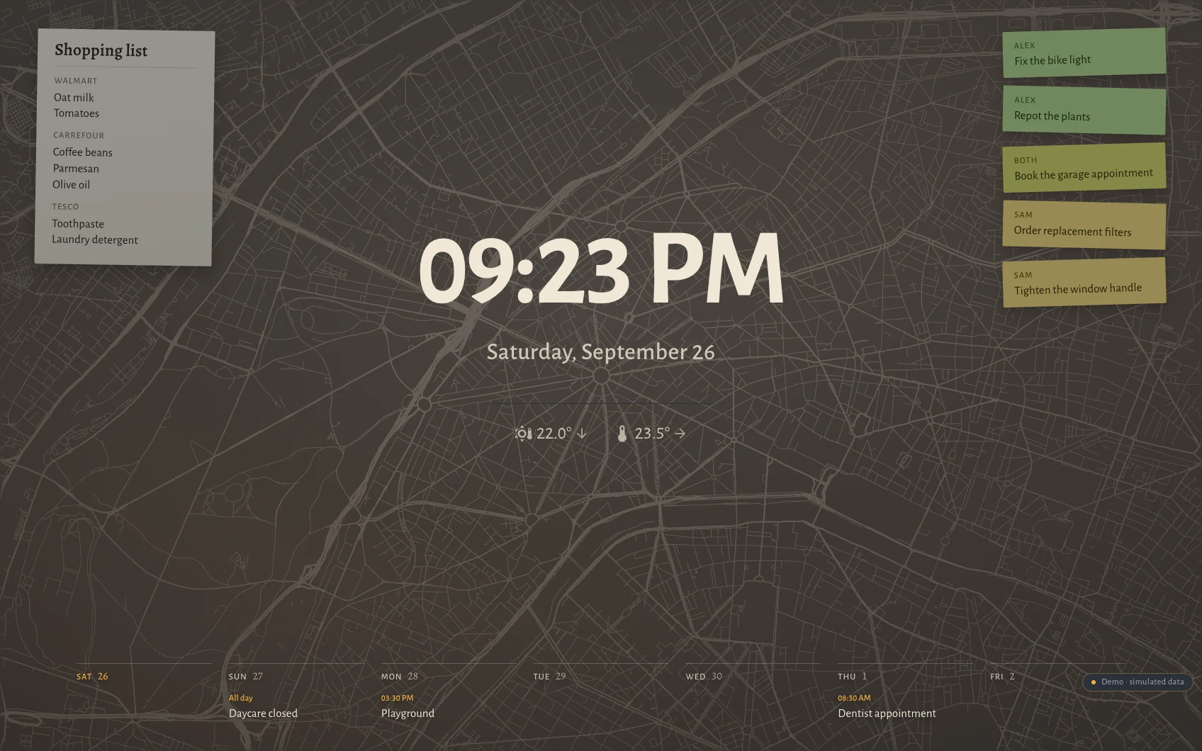 The Hauser standby screen at night in Paris: clock, date, the week as seven columns along the bottom, post-its and the shopping list over a faint street map showing the avenues meeting at the Étoile.